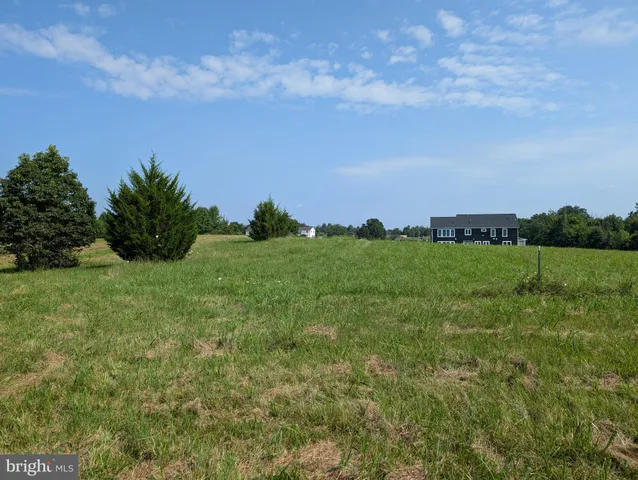 a view of a garden with a building in the background