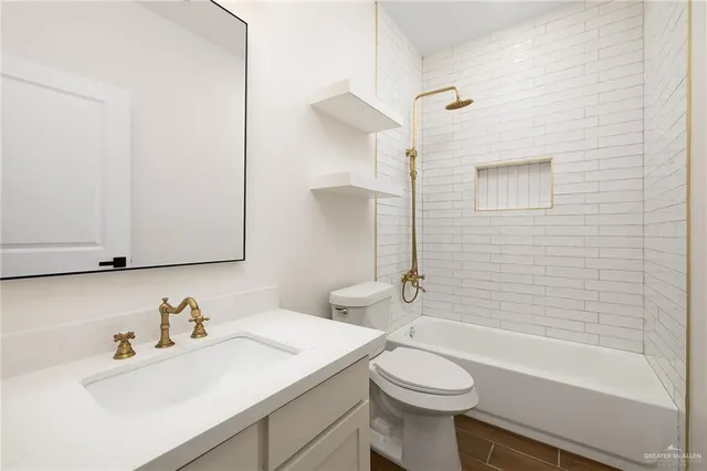 a bathroom with a sink toilet and tub