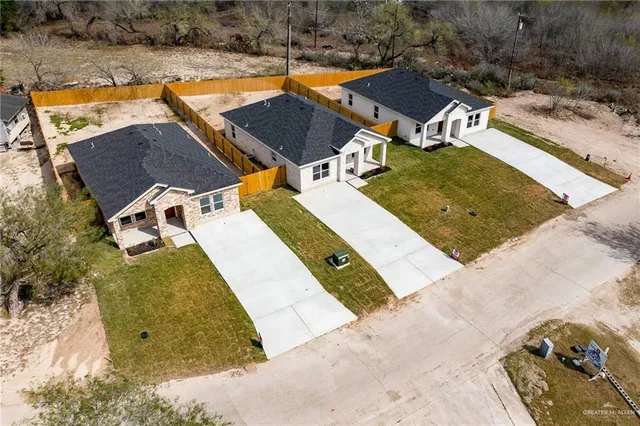 an aerial view of residential houses with outdoor space