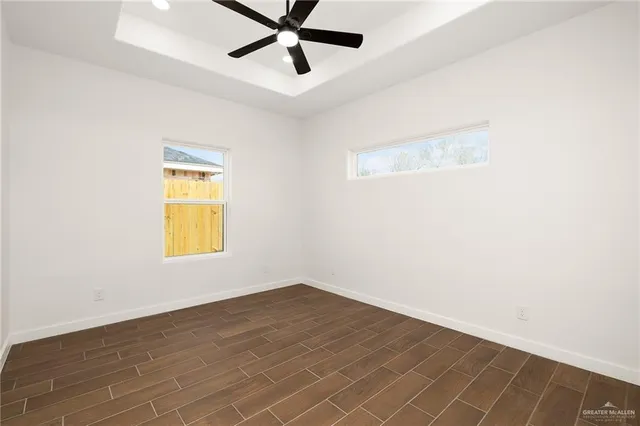 a view of a room with wooden floor and natural light