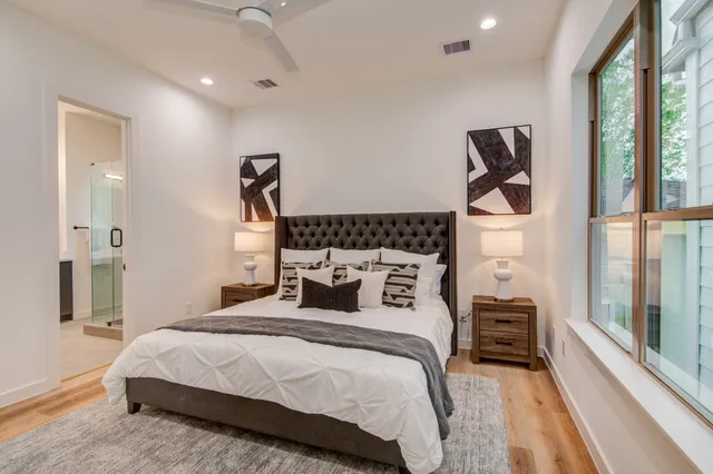 a bedroom with a bed next to a window