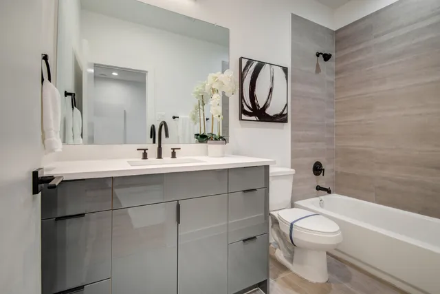 a kitchen with a sink a stove a refrigerator and chairs