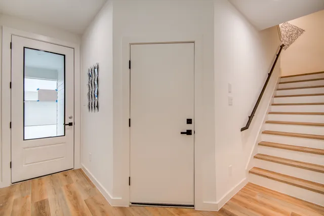 a living room with a table and potted plant