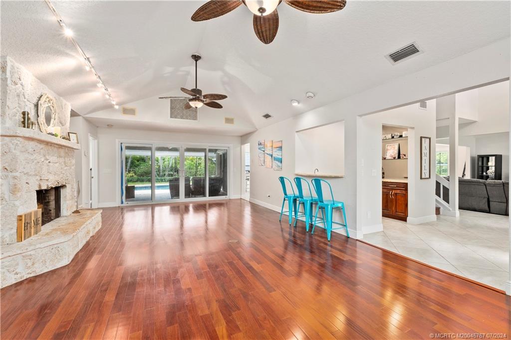 18770 Southeast River Ridge Road Jupiter, FL 33469 - Photo 14 of 81 a view of an empty room with wooden floor and a fireplace