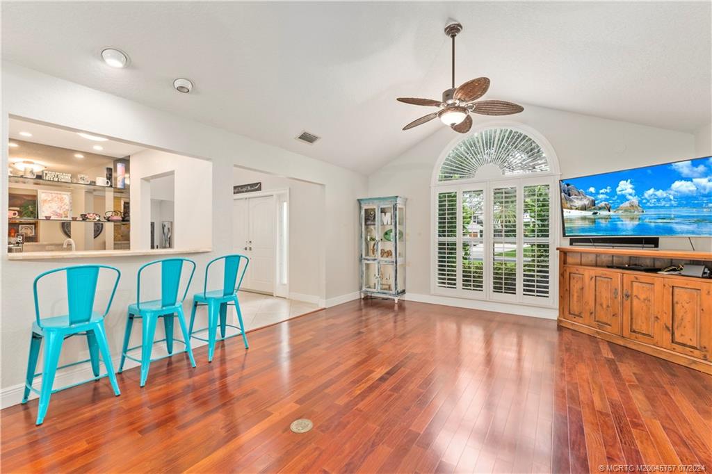 18770 Southeast River Ridge Road Jupiter, FL 33469 - Photo 15 of 81 a view of an empty room with window wooden floor and furniture