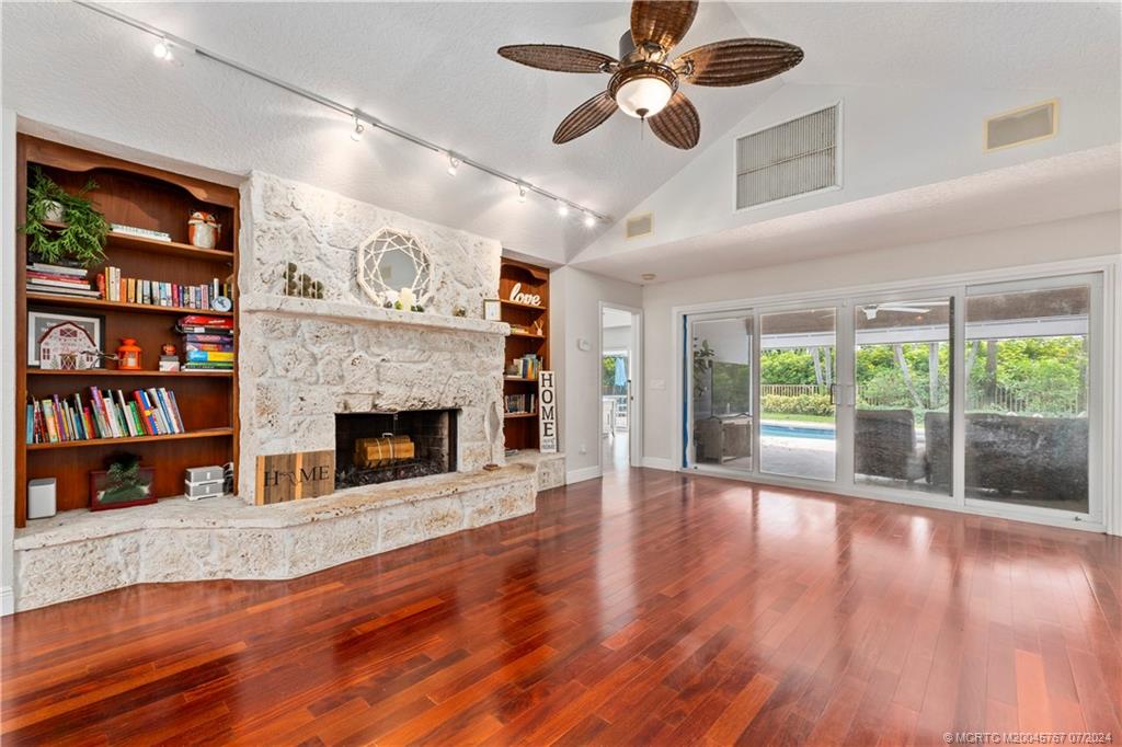 18770 Southeast River Ridge Road Jupiter, FL 33469 - Photo 18 of 81 a living room with furniture and a fireplace