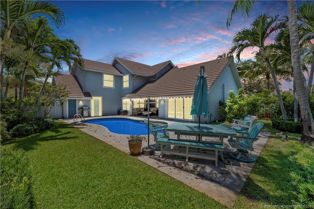 18770 Southeast River Ridge Road Jupiter, FL 33469 - Photo 2 of 81 a view of a house with backyard porch and sitting area