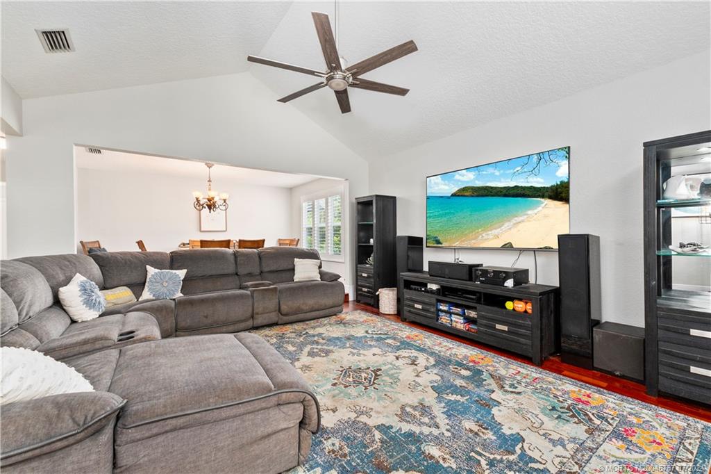 18770 Southeast River Ridge Road Jupiter, FL 33469 - Photo 23 of 81 a living room with furniture and a flat screen tv