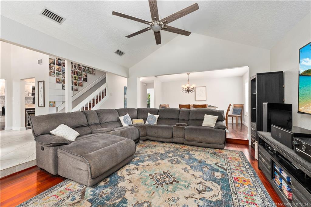 18770 Southeast River Ridge Road Jupiter, FL 33469 - Photo 24 of 81 a living room with furniture flat screen tv and a rug