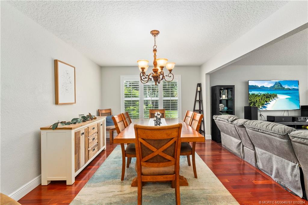 18770 Southeast River Ridge Road Jupiter, FL 33469 - Photo 25 of 81 a dining room with furniture window and wooden floor
