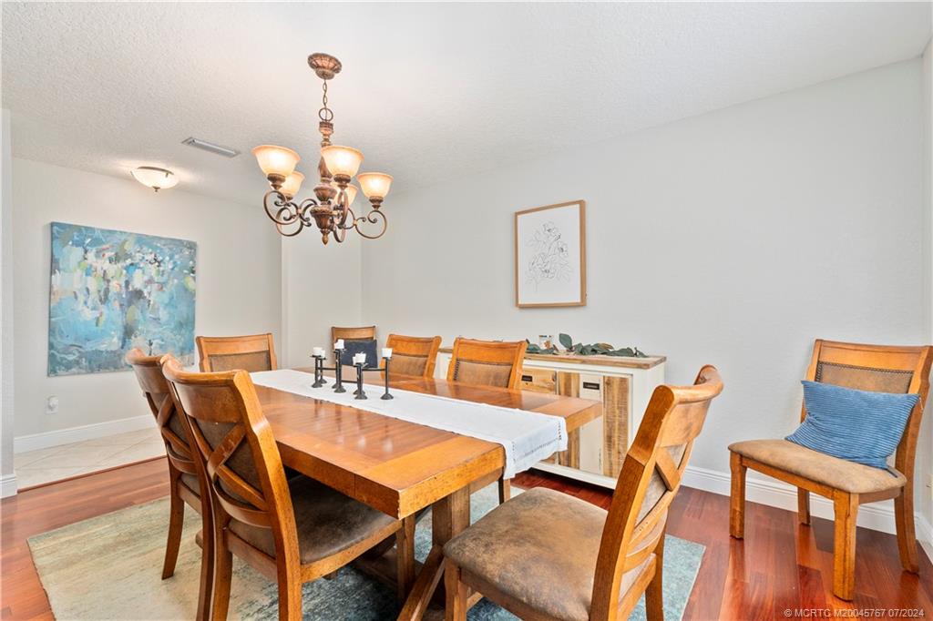 18770 Southeast River Ridge Road Jupiter, FL 33469 - Photo 27 of 81 a dining room with furniture and chandelier