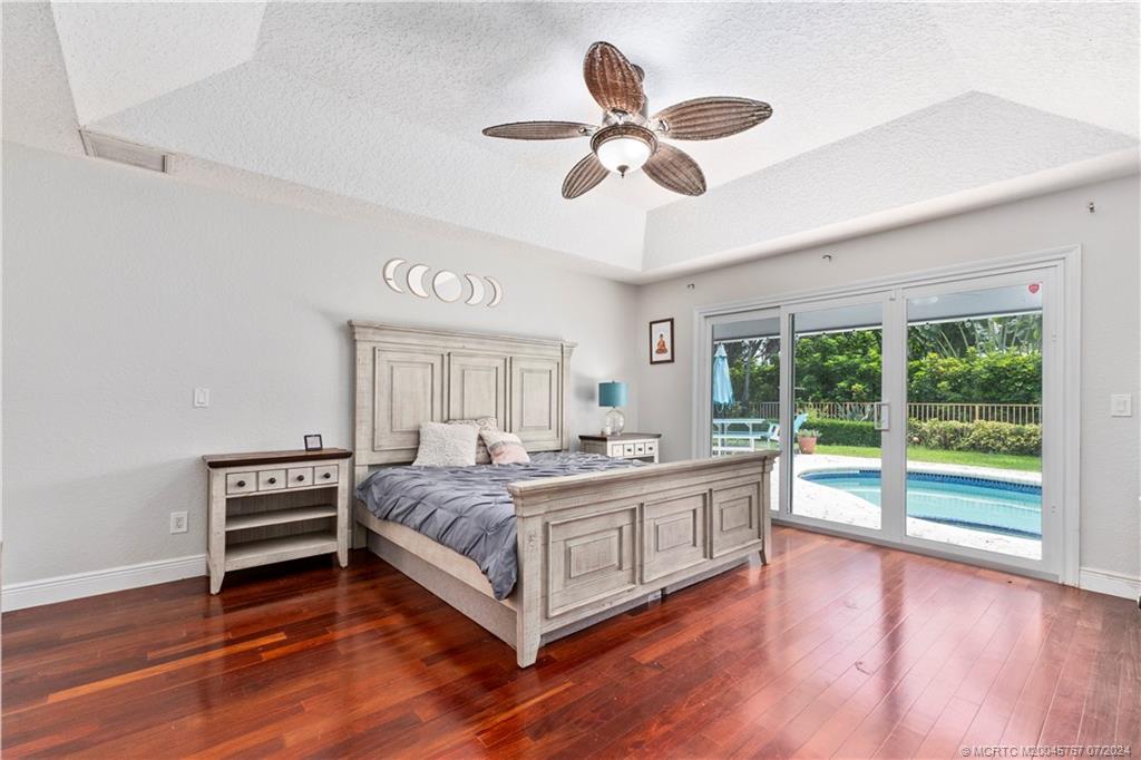 18770 Southeast River Ridge Road Jupiter, FL 33469 - Photo 28 of 81 a living room with a bed furniture and a large window