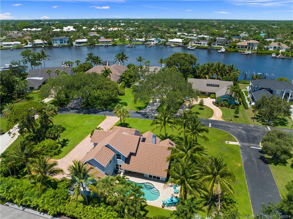 18770 Southeast River Ridge Road Jupiter, FL 33469 - Photo 3 of 81 an aerial view of lake residential houses with outdoor space and swimming pool