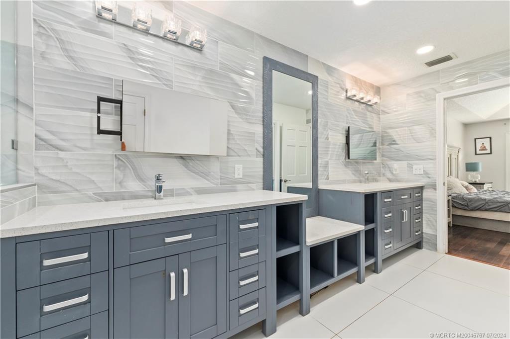 18770 Southeast River Ridge Road Jupiter, FL 33469 - Photo 33 of 81 a spacious bathroom with a granite countertop sink mirror and