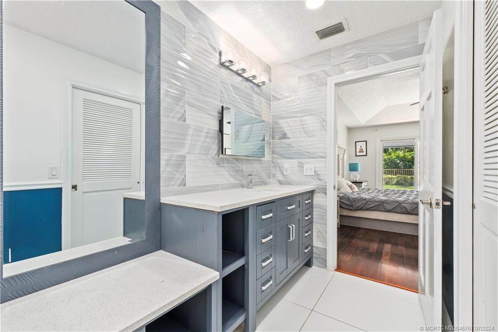 18770 Southeast River Ridge Road Jupiter, FL 33469 - Photo 34 of 81 a bathroom with a sink and a mirror