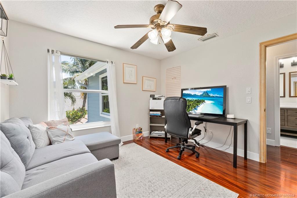 18770 Southeast River Ridge Road Jupiter, FL 33469 - Photo 42 of 81 a living room with furniture and a flat screen tv