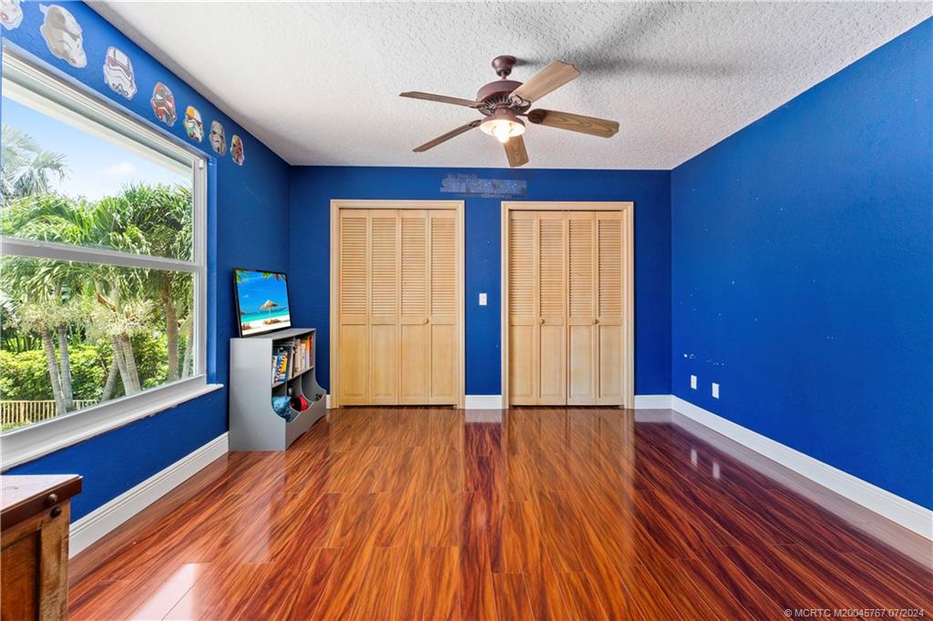 18770 Southeast River Ridge Road Jupiter, FL 33469 - Photo 48 of 81 a view of empty room with wooden floor and fan