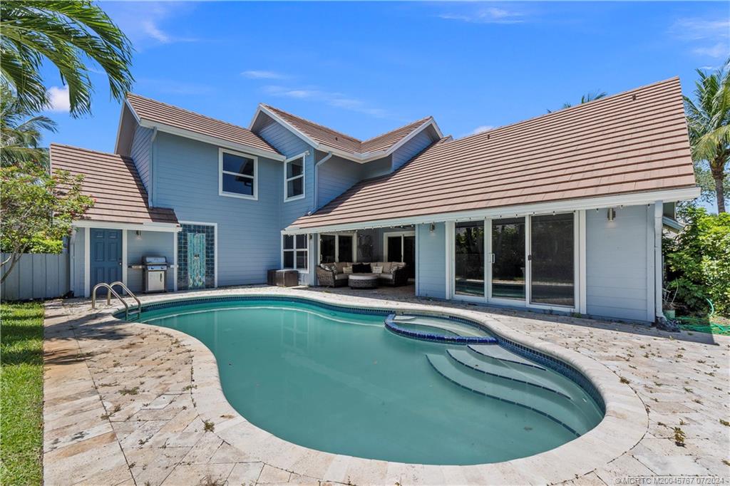 18770 Southeast River Ridge Road Jupiter, FL 33469 - Photo 58 of 81 a view of a house with swimming pool and sitting area