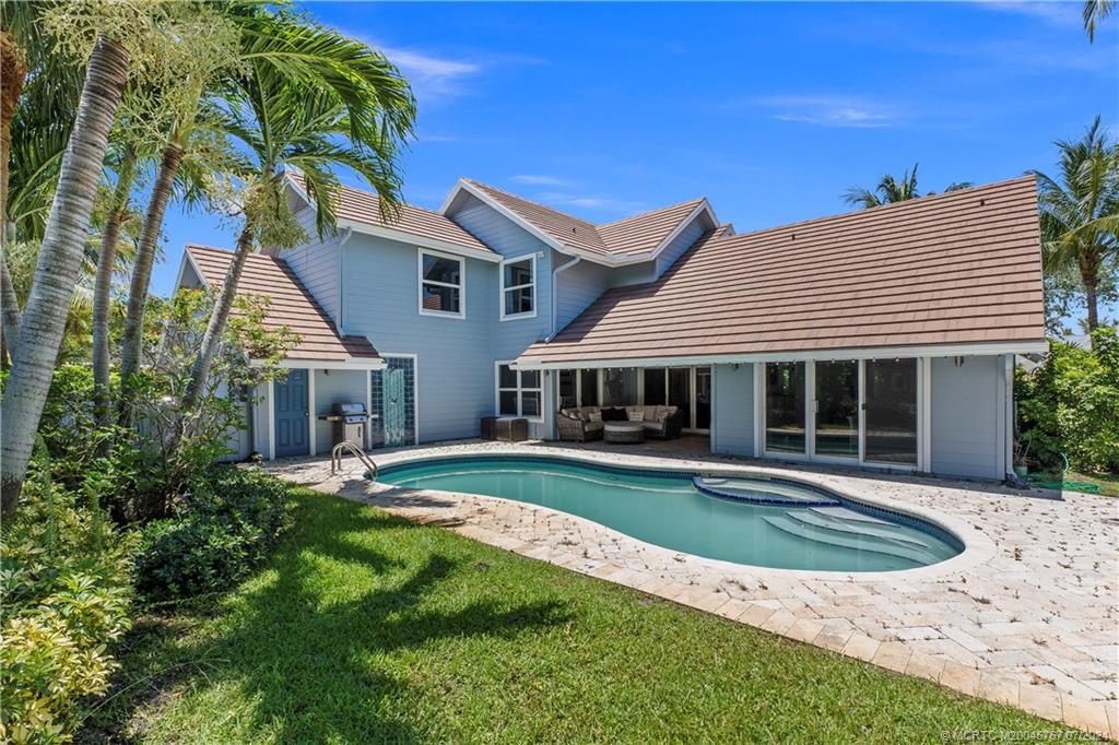 18770 Southeast River Ridge Road Jupiter, FL 33469 - Photo 60 of 81 a front view of a house with garden