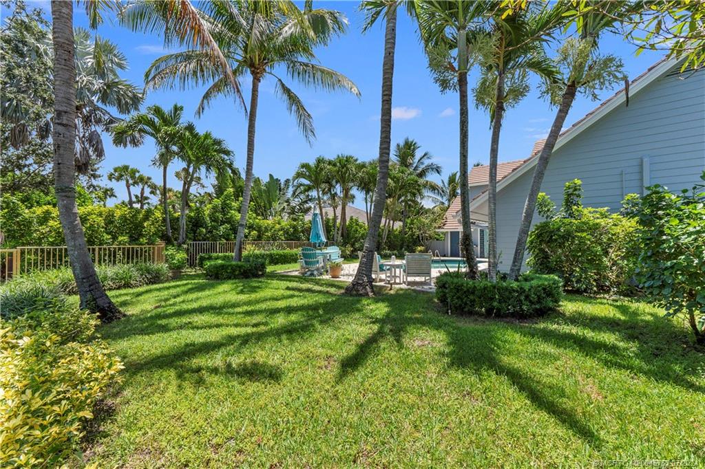 18770 Southeast River Ridge Road Jupiter, FL 33469 - Photo 65 of 81 a view of a backyard with a garden