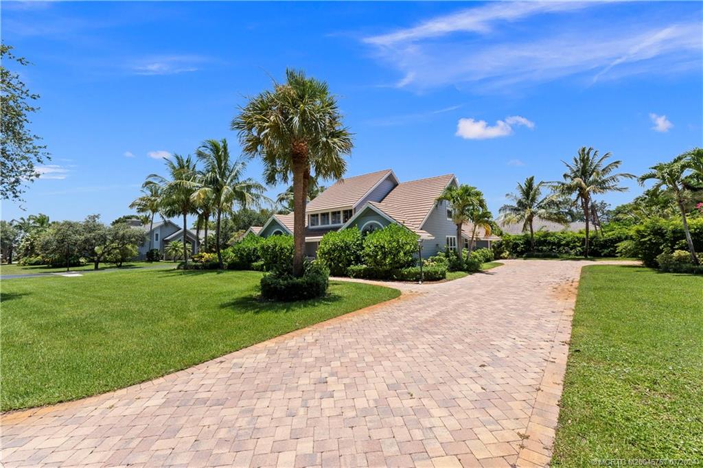 18770 Southeast River Ridge Road Jupiter, FL 33469 - Photo 68 of 81 a view of a garden with a building in the background