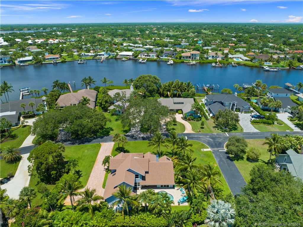18770 Southeast River Ridge Road Jupiter, FL 33469 - Photo 73 of 81 an aerial view of lake and residential houses with outdoor space and swimming pool