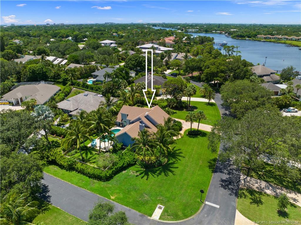 18770 Southeast River Ridge Road Jupiter, FL 33469 - Photo 77 of 81 an aerial view of residential houses with outdoor space and trees