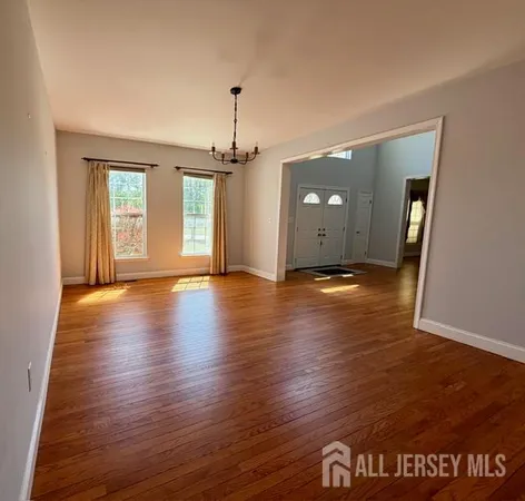 a view of a room with wooden floor