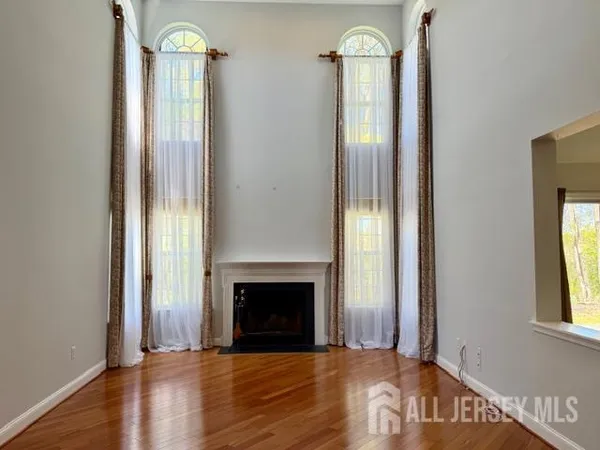 an empty room with windows cabinet and mirror