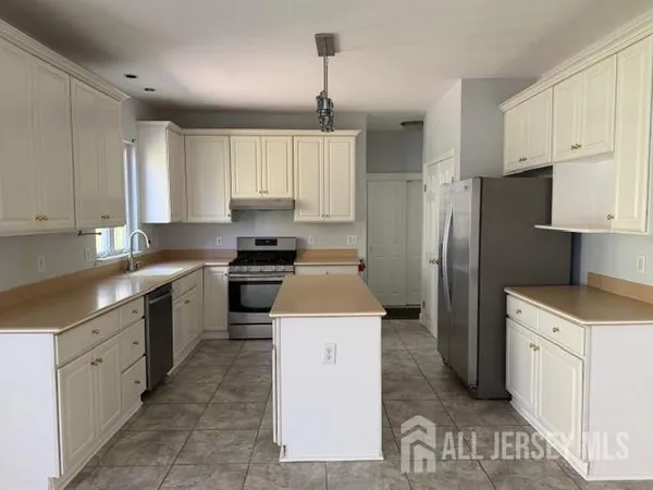 a kitchen with a sink stove and refrigerator