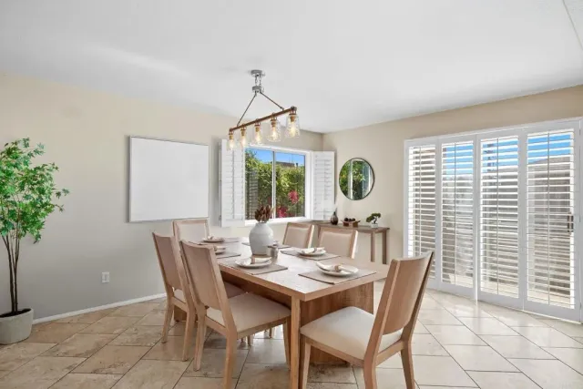 a dining room with furniture and window