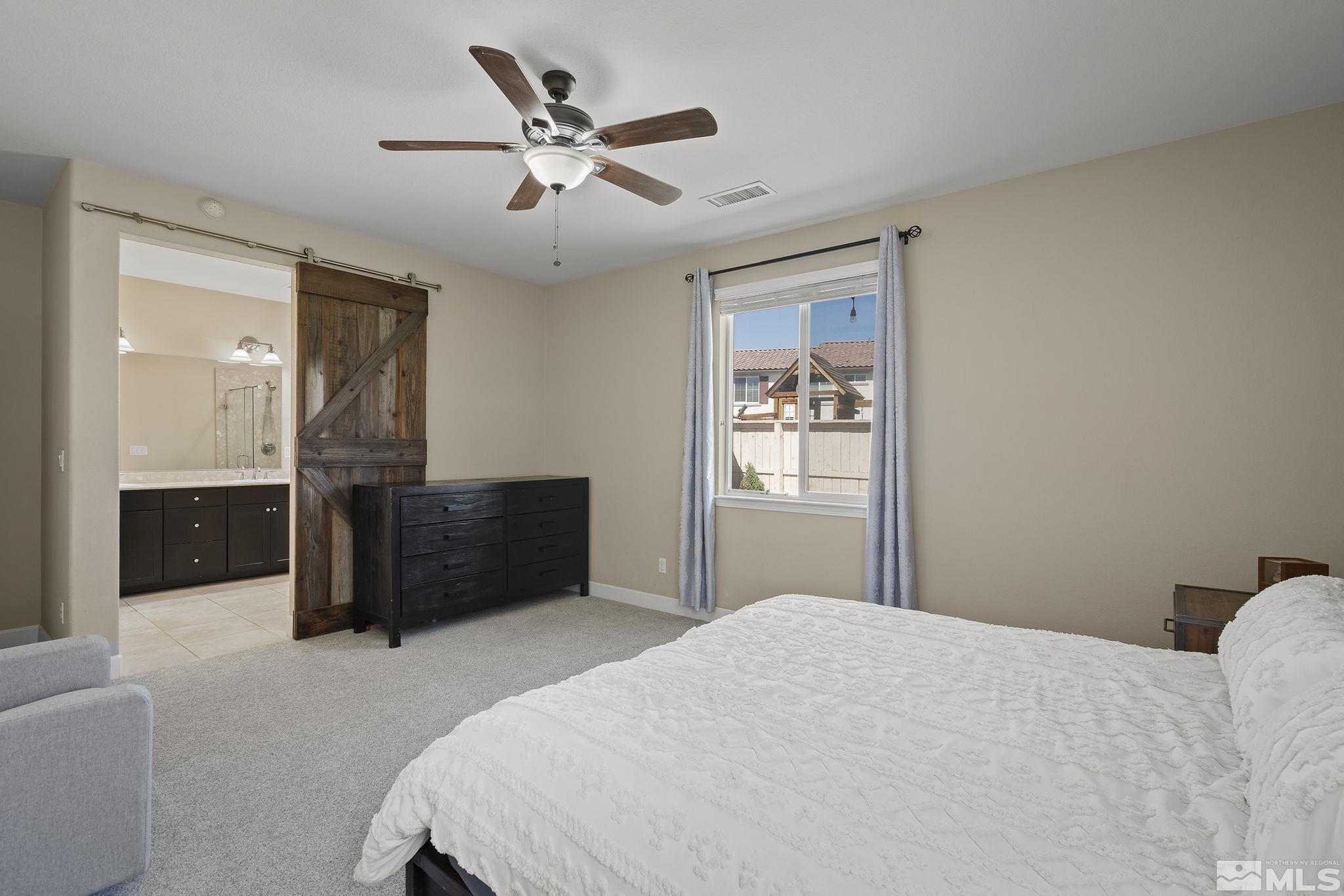 2135 Blue Oaks Drive Reno, NV 89521 - Photo 12 of 23 a bedroom with a bed and a chandelier