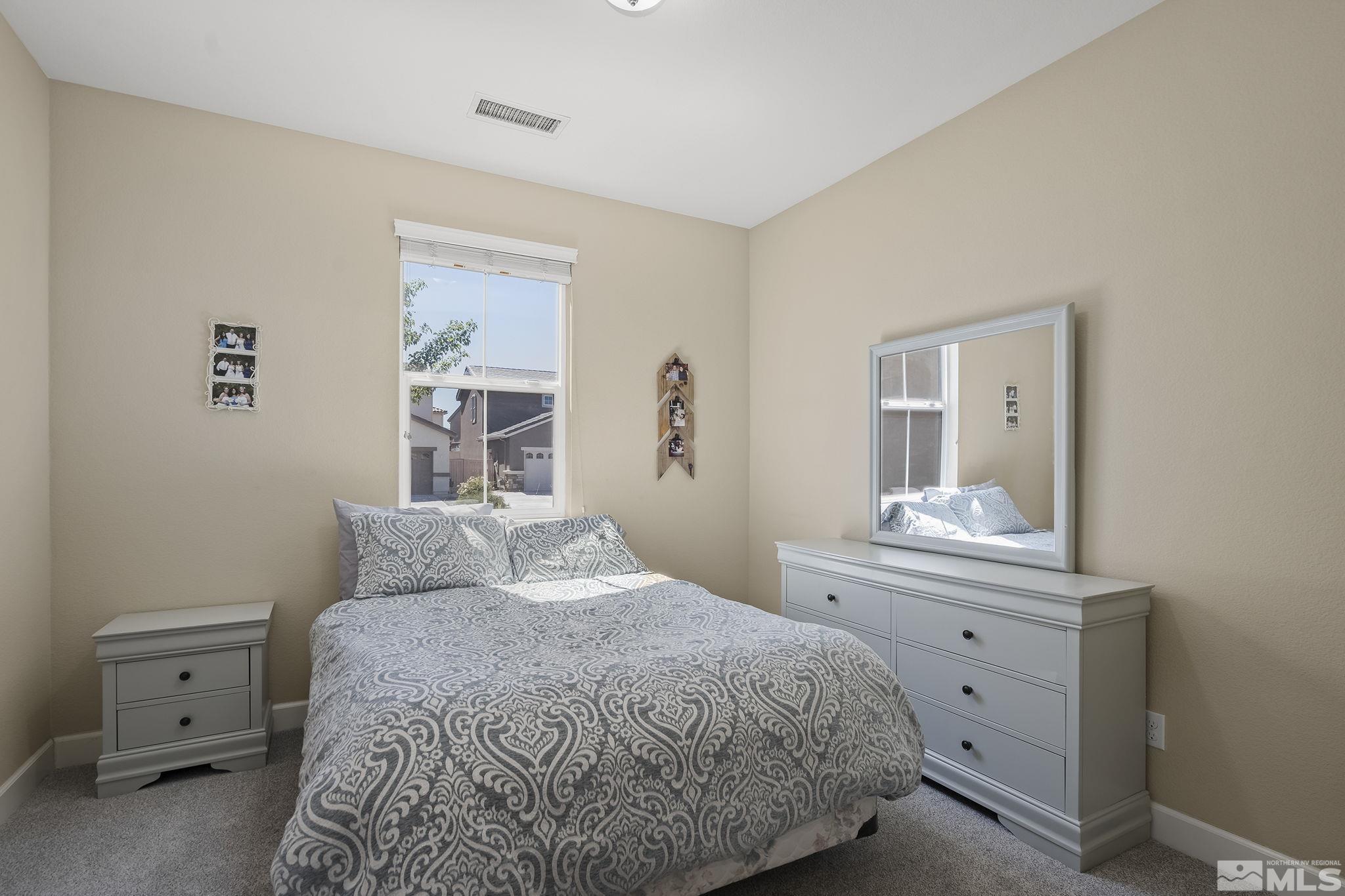 2135 Blue Oaks Drive Reno, NV 89521 - Photo 14 of 23 a bedroom with a bed and a dresser