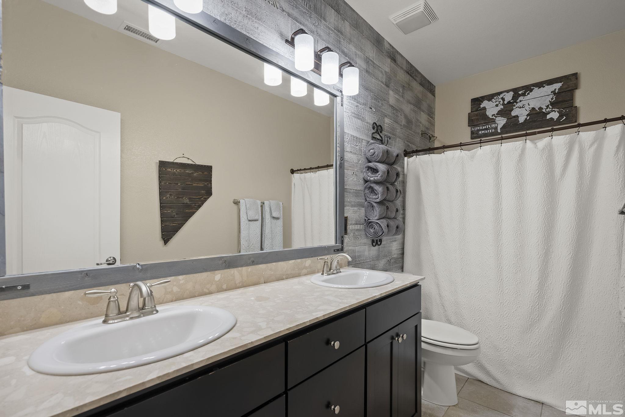 2135 Blue Oaks Drive Reno, NV 89521 - Photo 16 of 23 a bathroom with a double vanity sink and a mirror