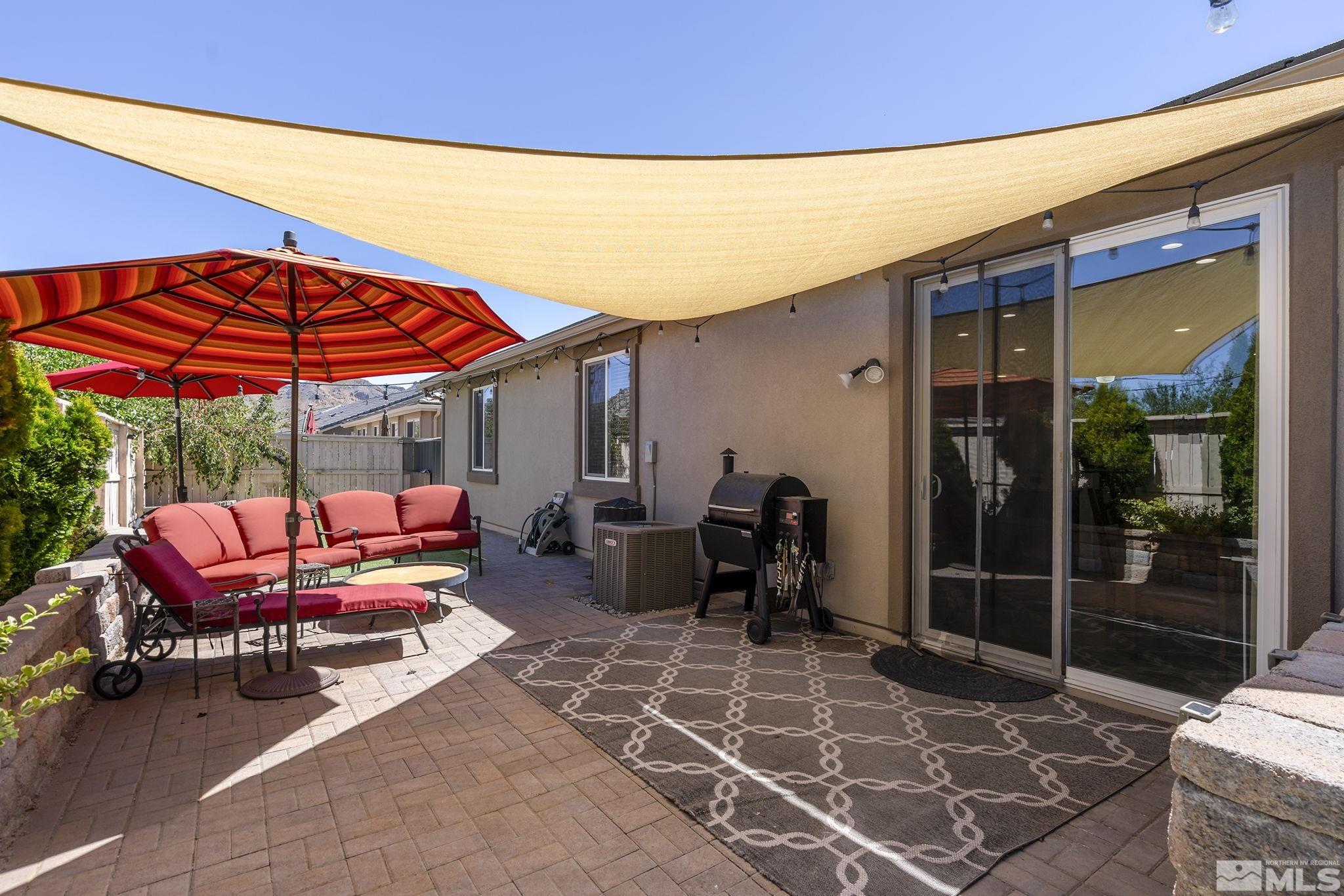 2135 Blue Oaks Drive Reno, NV 89521 - Photo 20 of 23 a patio with a table and chairs under an umbrella