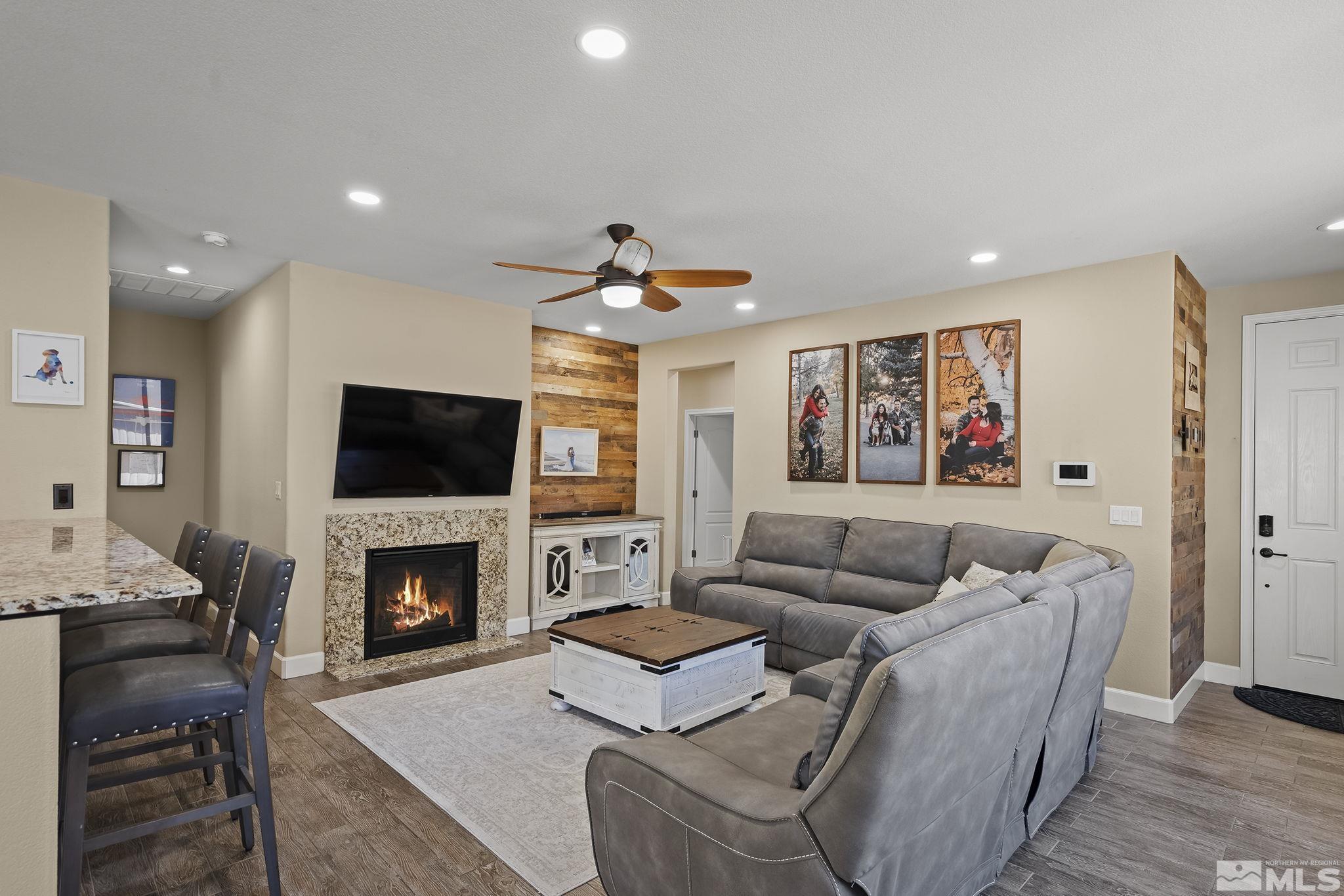 2135 Blue Oaks Drive Reno, NV 89521 - Photo 4 of 23 a living room with furniture a flat screen tv and a fireplace