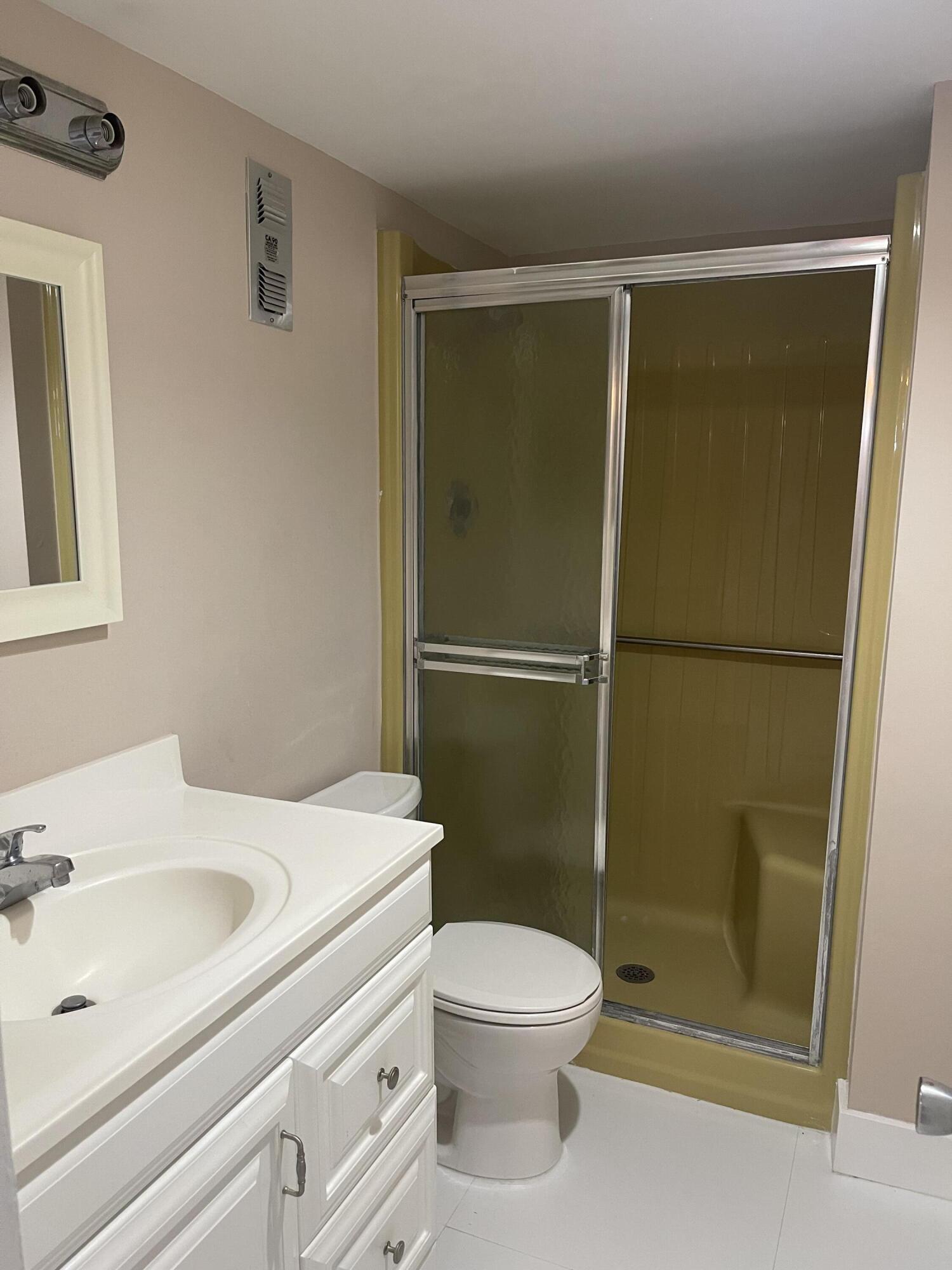 2300 Northeast 1st Lane, Unit 4020 Boynton Beach, FL 33435 - Photo 17 of 20 a bathroom with a sink a toilet and shower