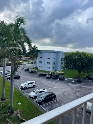 a view of a backyard with plants and outdoor seating
