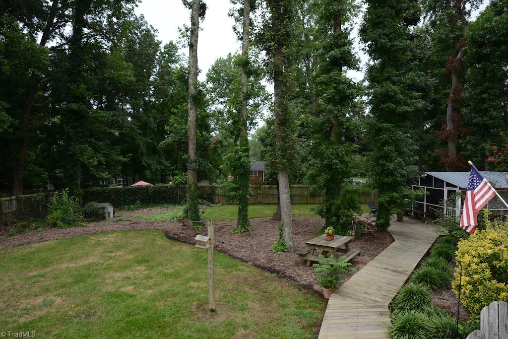 407 Walnut Grove Road Archdale, NC 27263 - Photo 28 of 30 Path from deck leads to storage building that had electricity and a screened in porch. Perfect to enjoying the backyard or even a man cave!