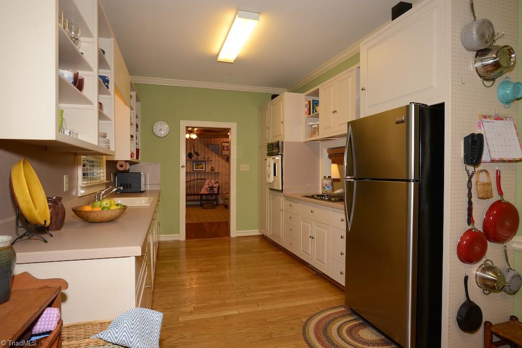 407 Walnut Grove Road Archdale, NC 27263 - Photo 6 of 30 Larger galley style kitchen is open to both living areas.
