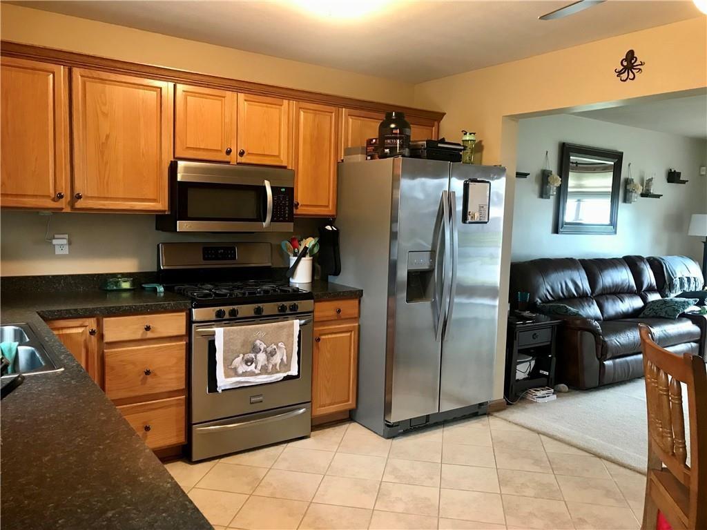 3421 Amherst Road Erie, PA 16506 - Photo 3 of 8 a kitchen with stainless steel appliances granite countertop a refrigerator and a stove top oven