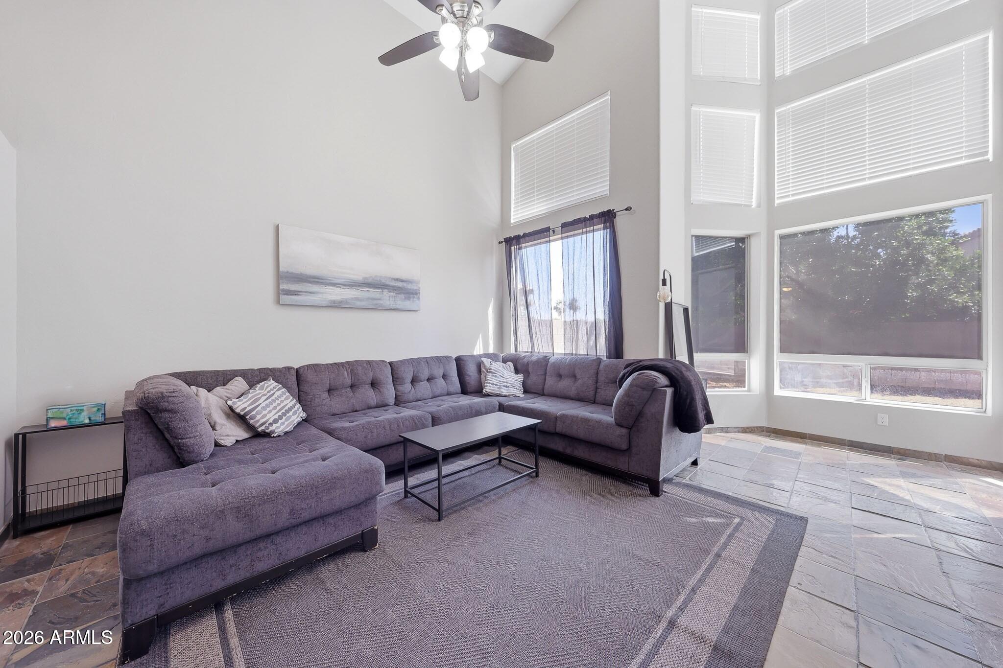 2167 East Nighthawk Way Phoenix, AZ 85048 - Photo 15 of 28 a living room with furniture and a large window