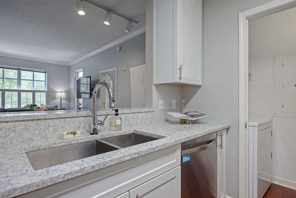 1101 Juniper Street Northeast, Unit 219 Atlanta, GA 30309 - Photo 11 of 31 a kitchen with a sink and a refrigerator