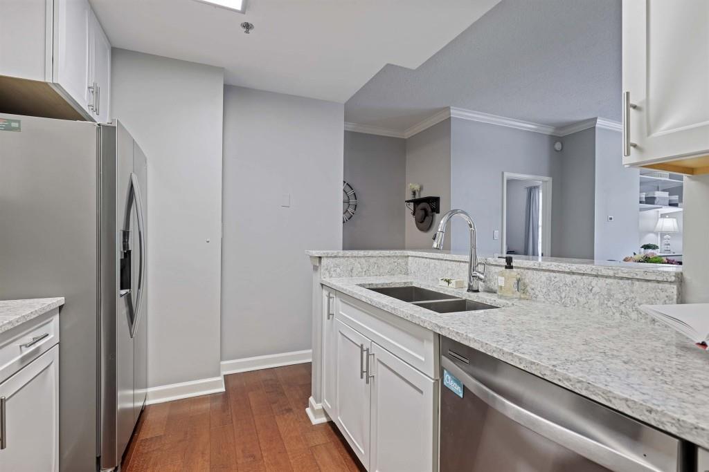 1101 Juniper Street Northeast, Unit 219 Atlanta, GA 30309 - Photo 12 of 31 a kitchen with a sink and a refrigerator
