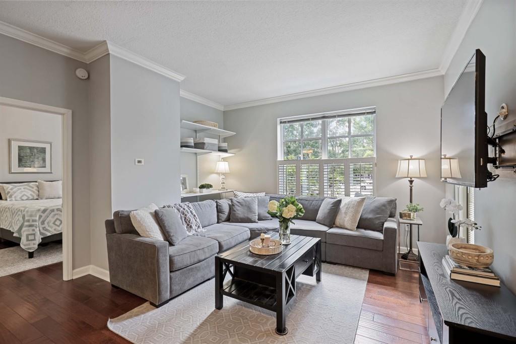 1101 Juniper Street Northeast, Unit 219 Atlanta, GA 30309 - Photo 7 of 31 a living room with furniture and a large window