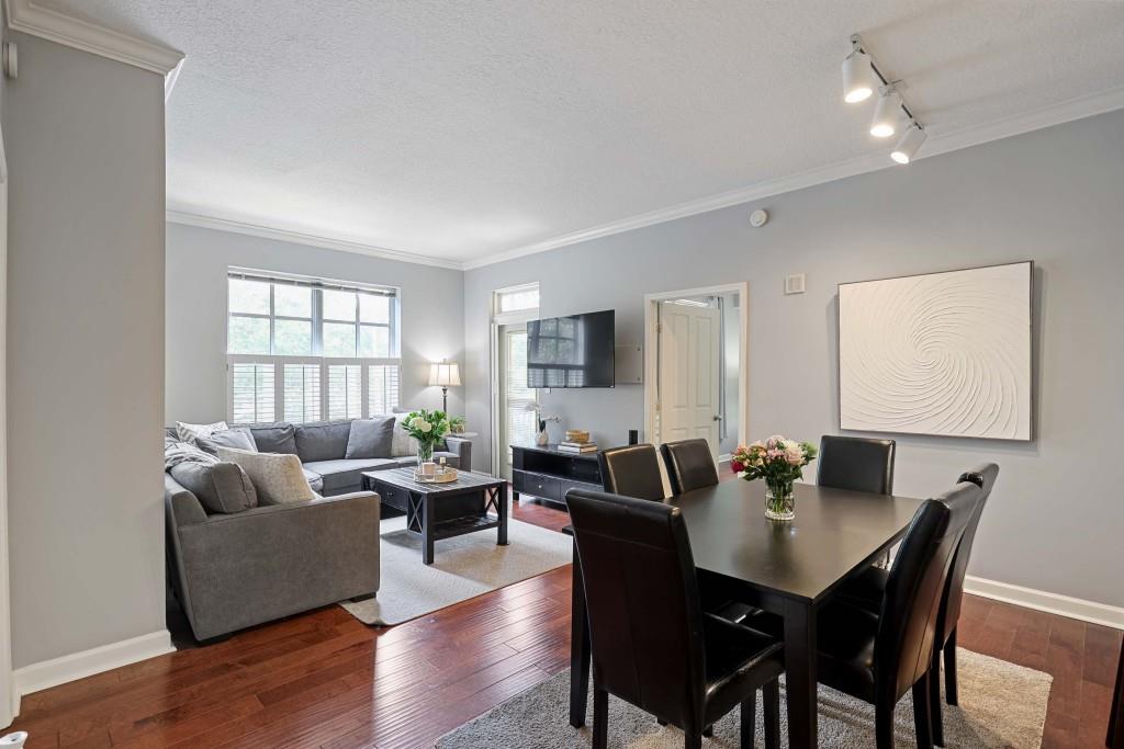 1101 Juniper Street Northeast, Unit 219 Atlanta, GA 30309 - Photo 8 of 31 a view of a dining room with furniture and wooden floor
