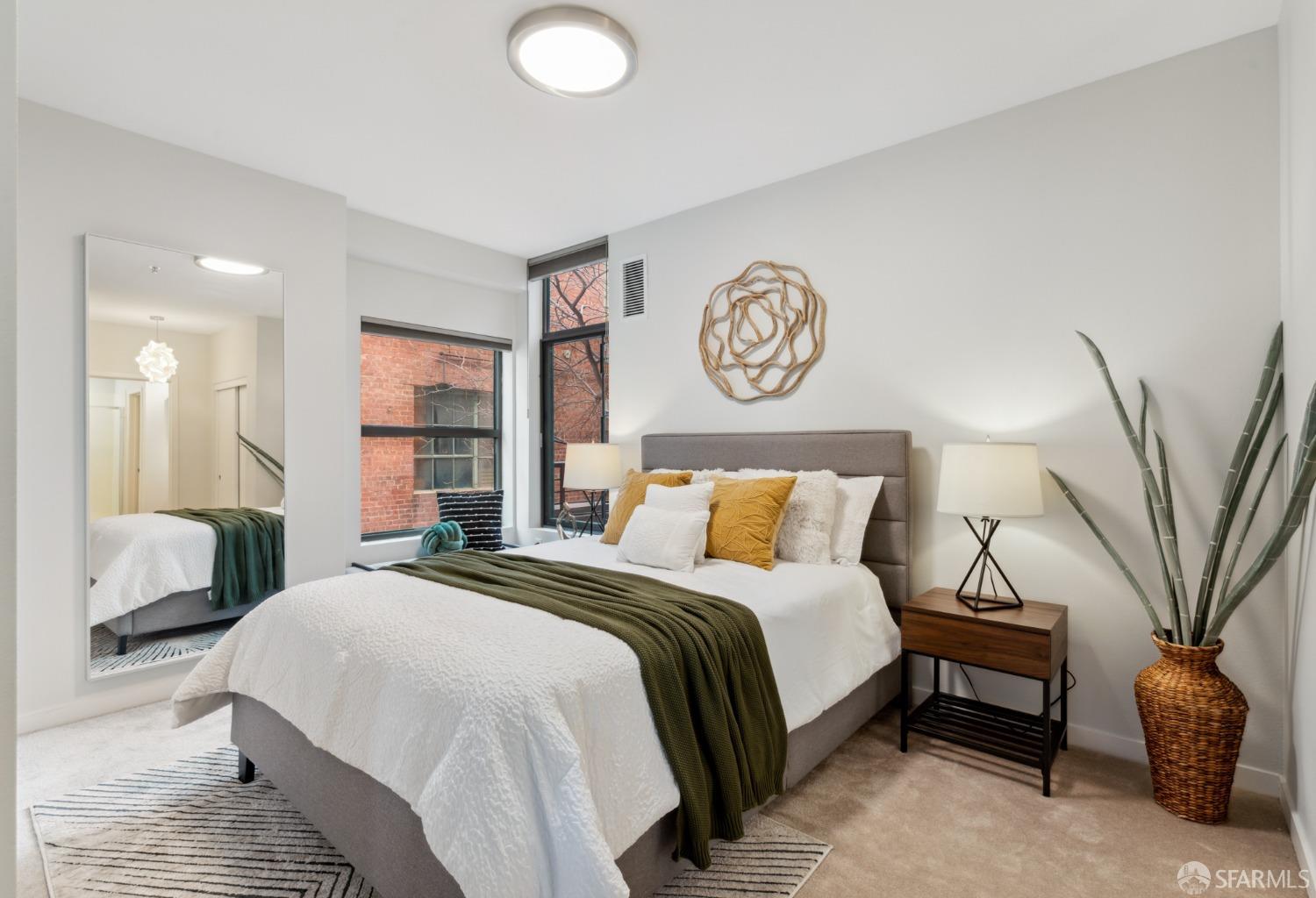 288 3rd Street, Unit 201 Oakland, CA 94607 - Photo 12 of 51 a bedroom with a bed and a lamp