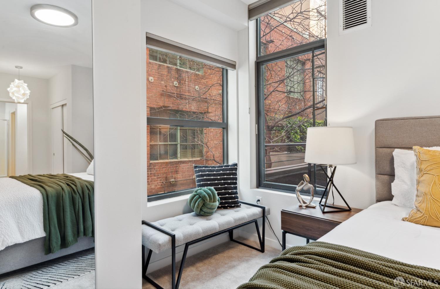 288 3rd Street, Unit 201 Oakland, CA 94607 - Photo 13 of 51 a living room with furniture and a window