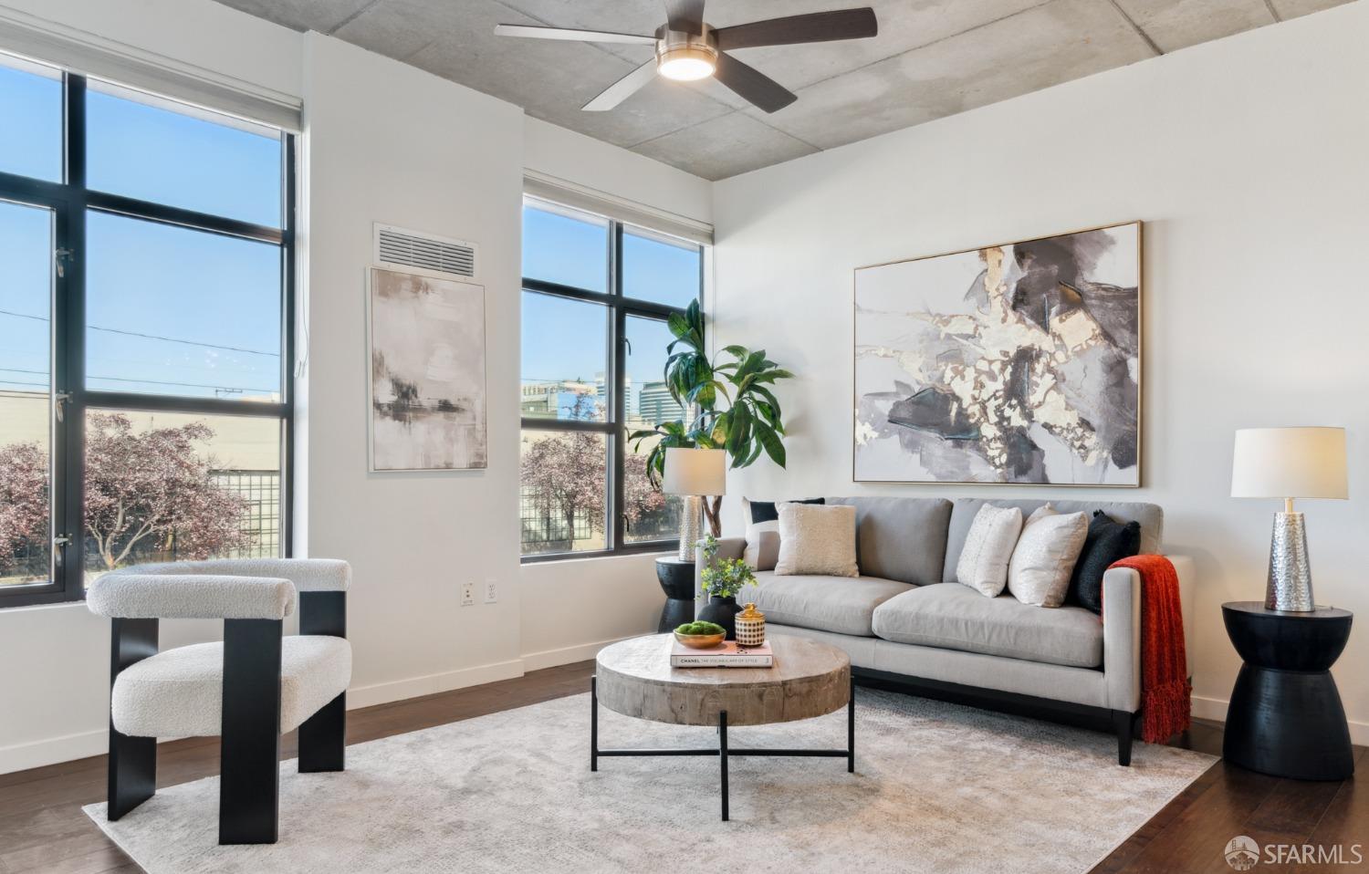 288 3rd Street, Unit 201 Oakland, CA 94607 - Photo 2 of 51 a living room with furniture and a large window