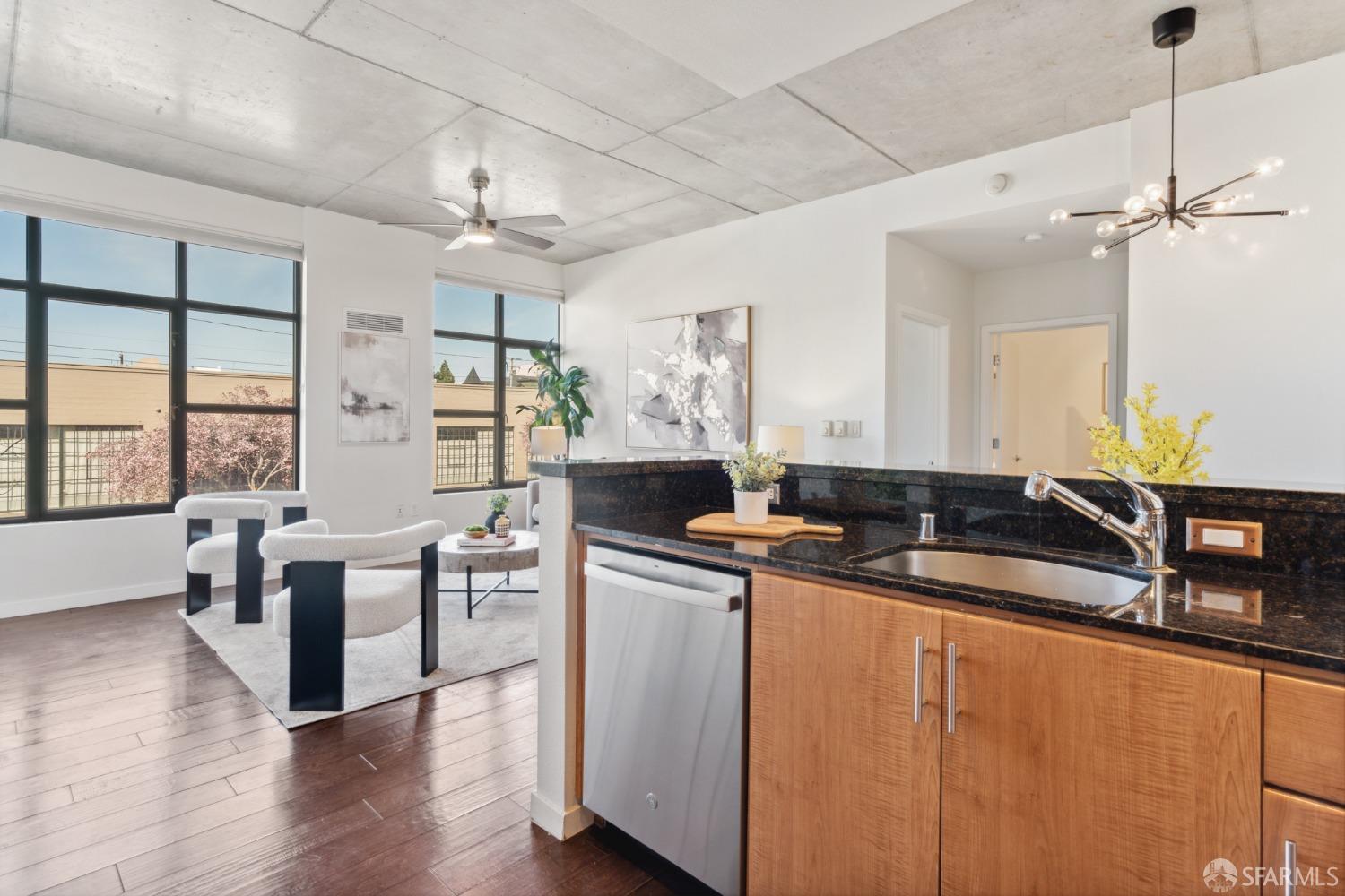 288 3rd Street, Unit 201 Oakland, CA 94607 - Photo 4 of 51 a kitchen with stainless steel appliances granite countertop a sink a stove and a wooden floors
